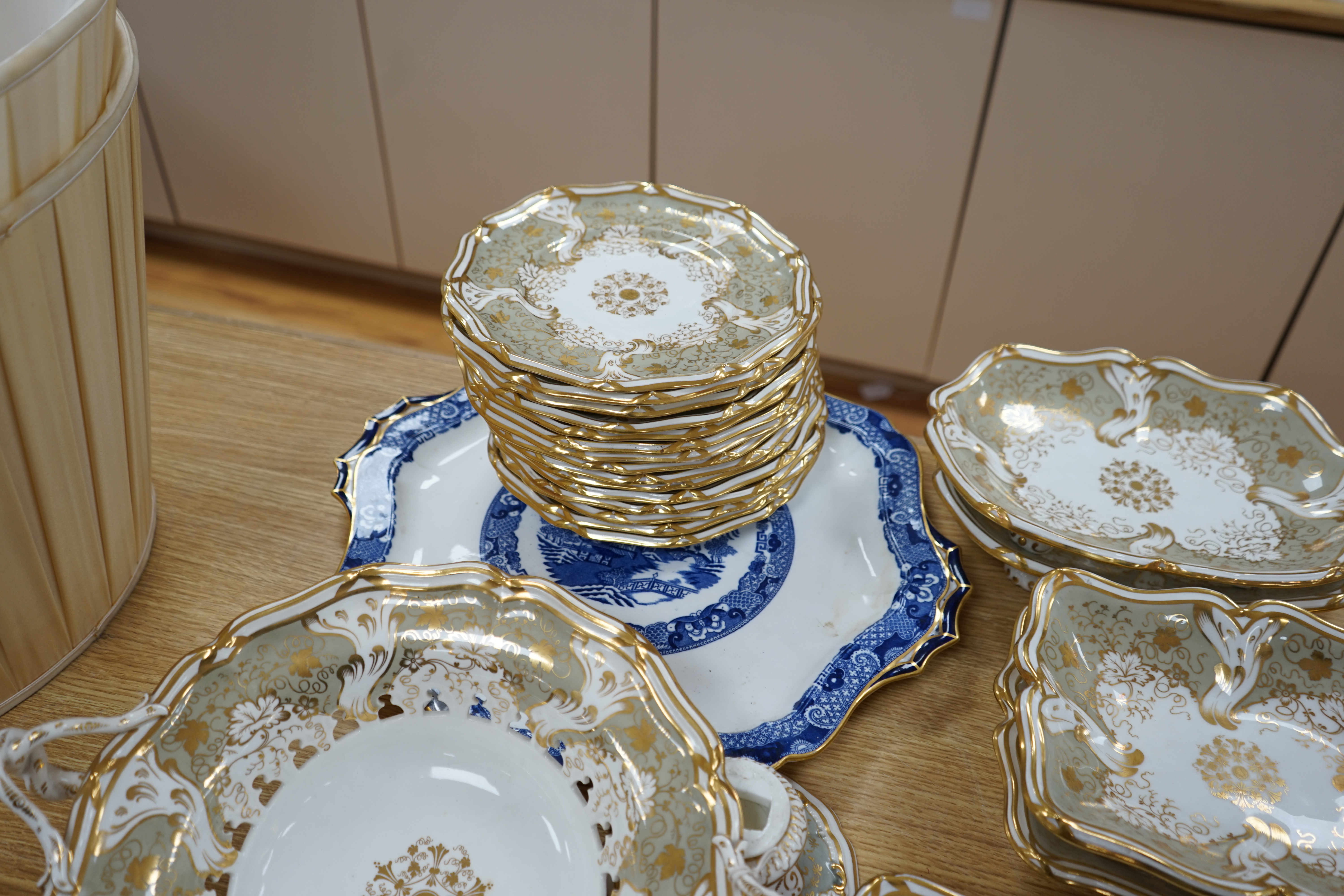 A Davenport part grey and gilt dessert service, together with a blue and white circular serving dish, dish 43cm wide. Condition - comport base broken